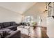 Bright living room with hardwood floors, vaulted ceiling, and ample natural light from large windows at 1663 E 96Th Pl, Thornton, CO 80229