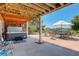 Relaxing back patio area with a hot tub, seating, and a well-maintained yard at 34827 E 7Th Ave, Watkins, CO 80137