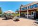 Stunning outdoor area with a patio, hot tub, grill, dining area, and seating under a two-story deck, perfect for entertaining at 34827 E 7Th Ave, Watkins, CO 80137