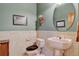 Powder room featuring stylish decor, sink, toilet, and custom mirror creating a welcoming space for guests at 34827 E 7Th Ave, Watkins, CO 80137
