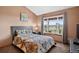Bedroom featuring a comfortable bed, natural light from the window, and a peaceful outdoor view at 34827 E 7Th Ave, Watkins, CO 80137