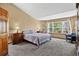 Bright bedroom featuring a large window offering natural light and views of surrounding trees at 34827 E 7Th Ave, Watkins, CO 80137