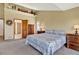 Bedroom featuring neutral walls, wood-trim, and a decor shelf above the door and closet entrances at 34827 E 7Th Ave, Watkins, CO 80137
