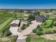 Aerial view of a property featuring a home, detached garage, and a long private driveway at 34827 E 7Th Ave, Watkins, CO 80137