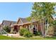 Attractive home featuring stone accents, a covered porch, and mature trees at 34827 E 7Th Ave, Watkins, CO 80137