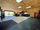 Spacious garage with a concrete floor, wood paneled ceiling and walls, and plenty of room for parking or projects at 34827 E 7Th Ave, Watkins, CO 80137
