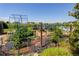 Backyard garden area with lush greenery, garden beds, and protective structures, designed for cultivating plants at 34827 E 7Th Ave, Watkins, CO 80137