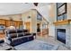 Inviting living room features a cozy fireplace, vaulted ceilings, and an open floor plan to the kitchen at 34827 E 7Th Ave, Watkins, CO 80137