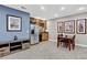 Open basement living space featuring a kitchenette, dining area, and stylish decor at 34827 E 7Th Ave, Watkins, CO 80137