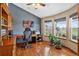 Bright home office with hardwood floors, large windows, and custom built-in shelving at 34827 E 7Th Ave, Watkins, CO 80137