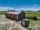 Spacious outbuilding on a large lot, featuring a metal roof, gravel path, and ample room for various activities at 34827 E 7Th Ave, Watkins, CO 80137