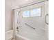 Bathroom showing shower and tub area with grab bars at 4395 E Arapahoe Pl, Centennial, CO 80122