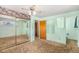 Bedroom featuring closet with mirrored doors and access to bathroom at 4395 E Arapahoe Pl, Centennial, CO 80122