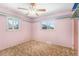 Bedroom with pink walls, a ceiling fan, and windows at 4395 E Arapahoe Pl, Centennial, CO 80122