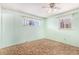 Bedroom with light green walls, ceiling fan, and windows at 4395 E Arapahoe Pl, Centennial, CO 80122