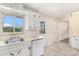 Bright kitchen featuring all-white cabinetry, stainless sink and tile flooring at 4395 E Arapahoe Pl, Centennial, CO 80122