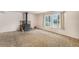 Cozy living room with a rustic fireplace, large windows, and neutral carpet at 4395 E Arapahoe Pl, Centennial, CO 80122