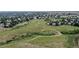 Aerial view of a neighborhood walking path surrounded by open green spaces at 32 Whitehaven Cir, Highlands Ranch, CO 80129