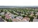Expansive aerial view of a residential neighborhood with lush greenery and mountain views at 32 Whitehaven Cir, Highlands Ranch, CO 80129