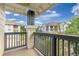 Covered balcony offers neighborhood views and ample privacy with wood railings at 32 Whitehaven Cir, Highlands Ranch, CO 80129