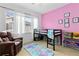 Bright bedroom featuring a pink accent wall, fun decor, and a loft bed with windows at 32 Whitehaven Cir, Highlands Ranch, CO 80129