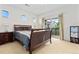 Primary bedroom with carpet floors, natural light, and balcony access at 32 Whitehaven Cir, Highlands Ranch, CO 80129