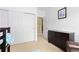 Bedroom featuring closet with sliding doors, a dark dresser and view into the hallway at 32 Whitehaven Cir, Highlands Ranch, CO 80129