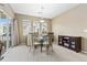 Bright dining room featuring a glass table, four chairs, and sliding doors to the outside at 32 Whitehaven Cir, Highlands Ranch, CO 80129