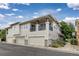 Inviting home featuring neutral siding, a cozy balcony, and a well-maintained front exterior at 32 Whitehaven Cir, Highlands Ranch, CO 80129