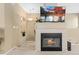 Inviting fireplace with tiled surround and mounted television, perfect for cozy evenings at 32 Whitehaven Cir, Highlands Ranch, CO 80129