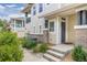 Charming home featuring front entrance with steps, landscaping and address number on door at 32 Whitehaven Cir, Highlands Ranch, CO 80129
