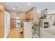 Kitchen with breakfast bar and adjacent fireplace at 32 Whitehaven Cir, Highlands Ranch, CO 80129