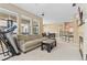 Spacious living room with comfortable seating, bright light, and open access to kitchen and dining area at 32 Whitehaven Cir, Highlands Ranch, CO 80129
