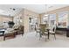 Open living space with dining area, comfortable seating, and lots of windows for natural light at 32 Whitehaven Cir, Highlands Ranch, CO 80129