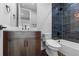 This bathroom features a dark-stained vanity and stylish blue tiled shower at 7611 Copper Sky Ct, Castle Pines, CO 80108
