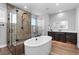 Luxurious bathroom showcasing a freestanding tub, glass-enclosed shower, and modern fixtures at 7611 Copper Sky Ct, Castle Pines, CO 80108