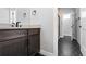 Modern bathroom with dark wood vanity, stylish fixtures, and shower at 7611 Copper Sky Ct, Castle Pines, CO 80108
