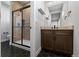 Well-lit bathroom featuring a tiled shower, modern vanity, and sleek fixtures at 7611 Copper Sky Ct, Castle Pines, CO 80108