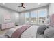 Cozy bedroom with large windows, stylish decor, and comfortable furnishings at 7611 Copper Sky Ct, Castle Pines, CO 80108