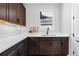 Charming butler's pantry with quartz countertops, dark cabinets and natural light from window at 7611 Copper Sky Ct, Castle Pines, CO 80108