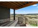 Covered deck boasting beautiful views of the surrounding landscape and rustic wood features at 7611 Copper Sky Ct, Castle Pines, CO 80108