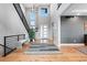 Bright foyer featuring high ceilings, modern staircase, and hardwood floors at 7611 Copper Sky Ct, Castle Pines, CO 80108