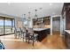 Spacious kitchen features a large center island, modern lighting and beautiful wood floors at 7611 Copper Sky Ct, Castle Pines, CO 80108