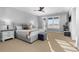 Spacious main bedroom boasting neutral tones, plush bedding, and an abundance of natural light at 7611 Copper Sky Ct, Castle Pines, CO 80108