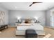 Bright main bedroom with a plush queen bed, stylish bedside tables, and an ensuite bathroom at 7611 Copper Sky Ct, Castle Pines, CO 80108