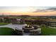 Outdoor patio featuring a built-in grill, fire pit, and stunning views of the landscape at 7611 Copper Sky Ct, Castle Pines, CO 80108