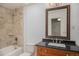 Bathroom featuring a vanity with a dark countertop, tiled walls, and a shower-tub combo at 1962 S Ivory Way, Aurora, CO 80013