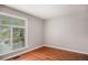 Bedroom with hardwood floors and natural light coming from large window at 1962 S Ivory Way, Aurora, CO 80013