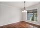 Bright dining room with hardwood floors and a large window with natural light at 1962 S Ivory Way, Aurora, CO 80013