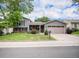 Charming two-story home with a well-manicured lawn, mature trees, and a two-car garage at 1962 S Ivory Way, Aurora, CO 80013